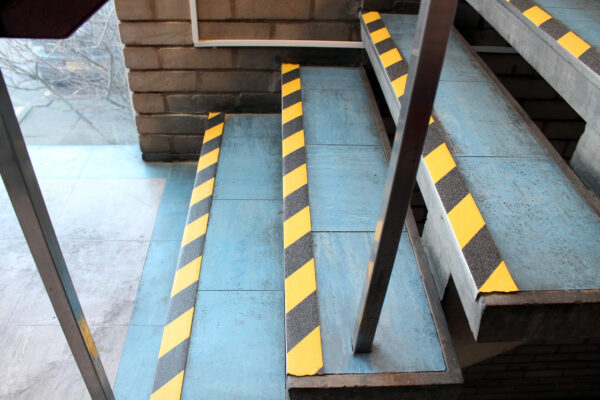 Hazardous tape on blue stair edges