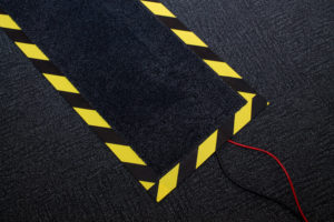 Wires covered by a hazardous marked mat