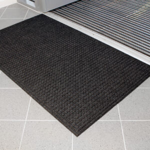 Black Eco-Doormat inside a door entrance