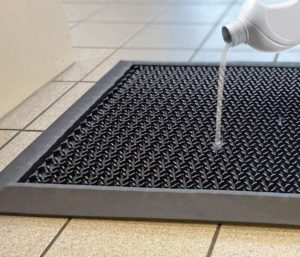 Liquid being poured on a Hygienic Floor Mat