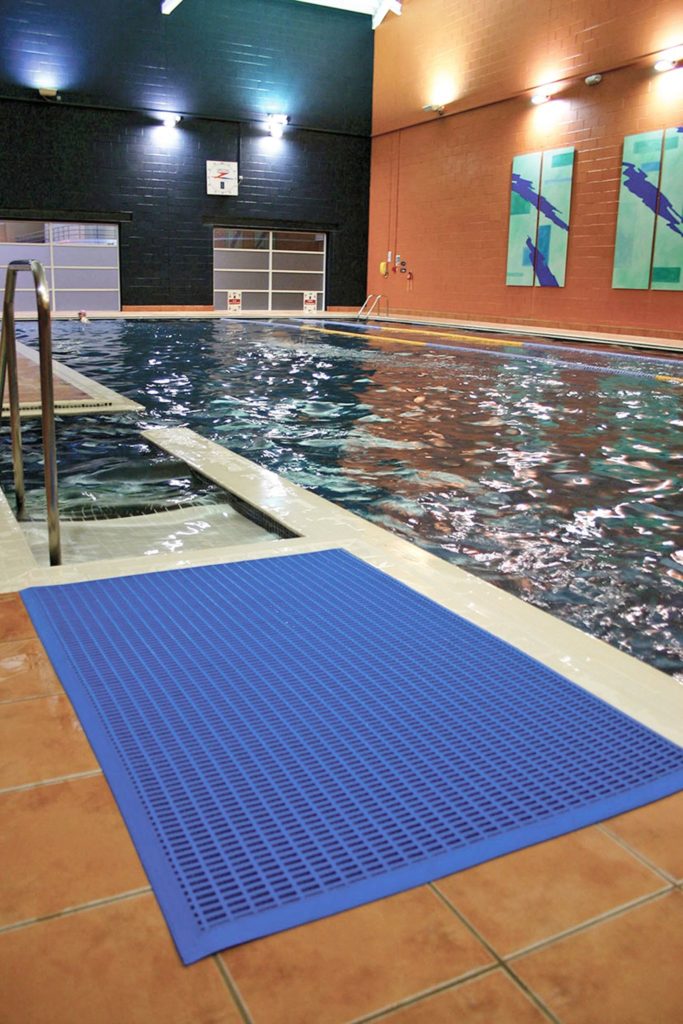 Blue leisure mat beside steps into a swimming pool