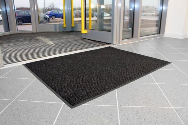 Charcoal Ribbed Carpet Doormat outside entry to a building
