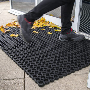 Woman walking on tough rubber outdoor mat
