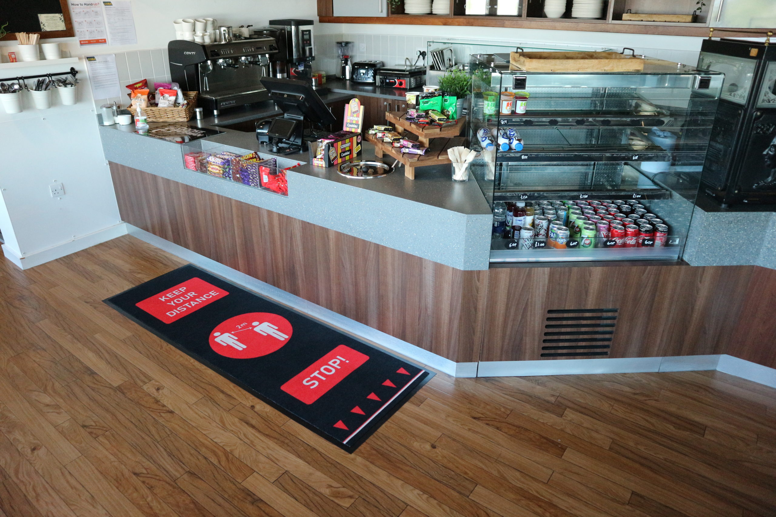 Red Social Distancing Mat by a cafe counter