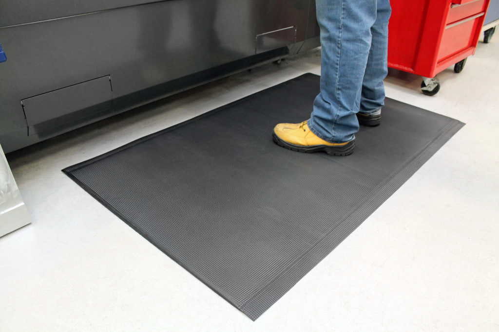man standing on a black ultimate anti-fatigue mat